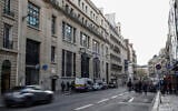 Police and security stand outside a Bank of America building following an apparent attempted bombing attack in the 8th arrondissement of Paris, France, March 28, 2026. (Sebastien DUPUY / AFP)