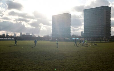 Illustrative: People play soccer outdoor in Wanstead Flats, in east London, January 23, 2021. (AP/Alberto Pezzali) Illustrative: People play soccer outdoor in Wanstead Flats, in east London, January 23, 2021. (AP/Alberto Pezzali)