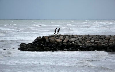 Two men walk on a pier at the southern coast of the Caspian Sea in port city of Bandar Anzali, Iran, December 2, 2024. (AP Photo/Vahid Salemi)
