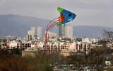 A kite flies over a park during the ancient annual public picnic day, called Sizdeh Bedar, in the 13th and last day of Nowruz, Iranian New Year holidays, in Tehran, Iran, April 2, 2025. (AP Photo/Vahid Salemi)