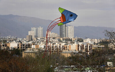 A kite flies over a park during the ancient annual public picnic day, called Sizdeh Bedar, in the 13th and last day of Nowruz, Iranian New Year holidays, in Tehran, Iran, April 2, 2025. (AP Photo/Vahid Salemi)