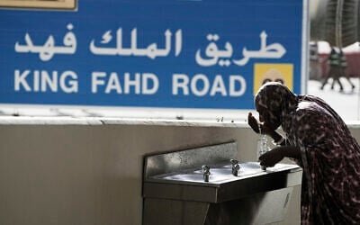 A Muslim pilgrim drinks water after she casts stones at pillars in the symbolic stoning of the devil, the last rite of the annual Hajj, in Mina near the holy city of Mecca, Saudi Arabia, June 7, 2025. (Amr Nabil/AP)