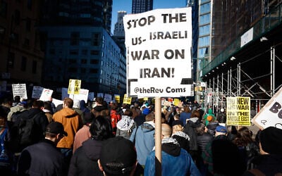 People attend a protest in New York, on Feb. 28, 2026, against US and Israeli strikes on Iran. (AP Photo/Kena Betancur)