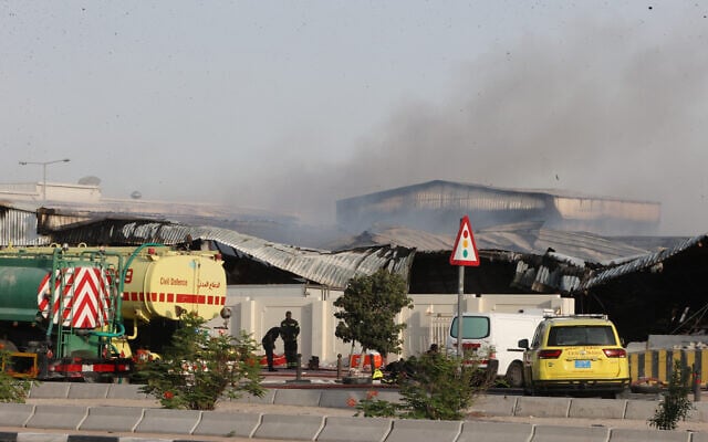 Firefighters work as smoke rises outside a damaged warehouse in an industrial area in Al Rayyan, Qatar, following an Iranian strike, Sunday, March 1, 2026. (AP Photo)