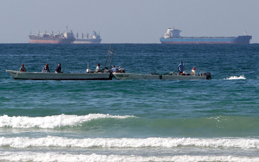Fishermen work in front of oil tankers south of the Strait of Hormuz Jan. 19, 2012, offshore the town of Ras Al Khaimah in United Arab Emirates. (AP/Kamran Jebreili)
