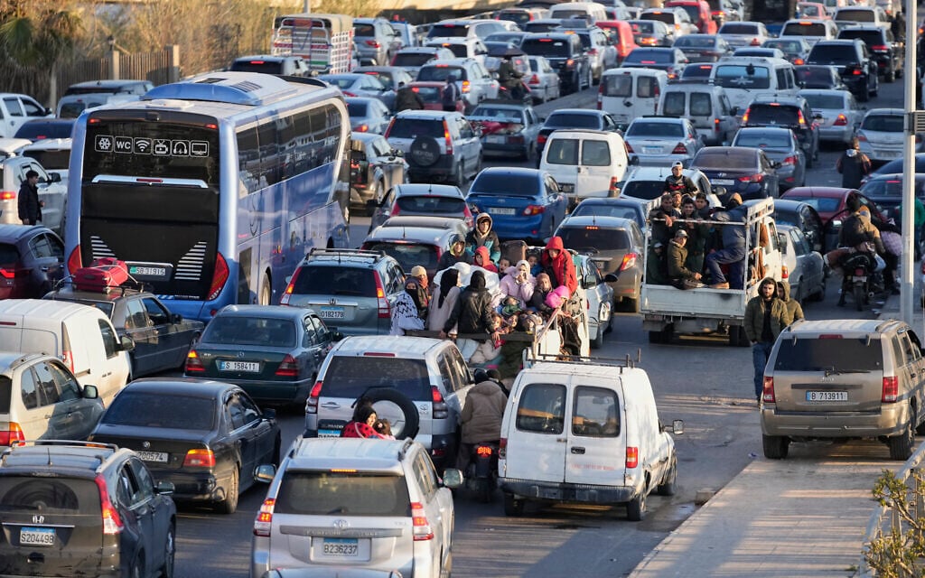 Displaced people fleeing Israeli strikes in southern Lebanon sit in traffic at a highway links to Beirut, in the southern port city of Sidon, March 2, 2026, after Hezbollah fired rockets into Israel. (AP Photo/Mohammed Zaatari)