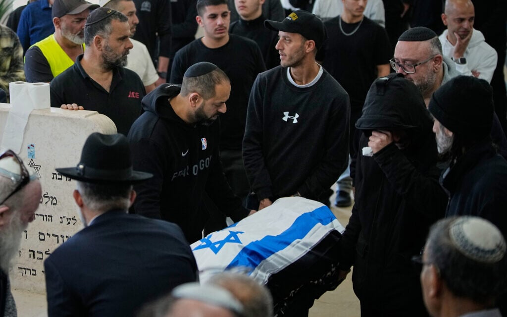 Mourners carry the flag-draped body of Oren Katz, who was killed in an Iranian missile attack, during his funeral in Beit Shemesh, Israel, Monday, March 2, 2026. (AP Photo/Ohad Zwigenberg)