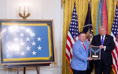 Chris Edmonds (left) son of US Master Sergeant Roderick Edmonds, with US President Donald Trump, is presented the Medal of Honor on behalf of his father, during a ceremony in the East Room of the White House, March 2, 2026, in Washington, DC. (AP/Alex Brandon)