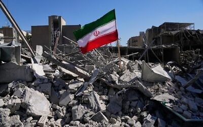 An Iranian flag is placed among the ruins of a police station struck during the US–Israeli bombing campaign in Tehran, Iran, March 3, 2026. (AP Photo/Vahid Salemi) An Iranian flag is placed among the ruins of a police station struck during the US–Israeli bombing campaign in Tehran, Iran, March 3, 2026. (AP Photo/Vahid Salemi)