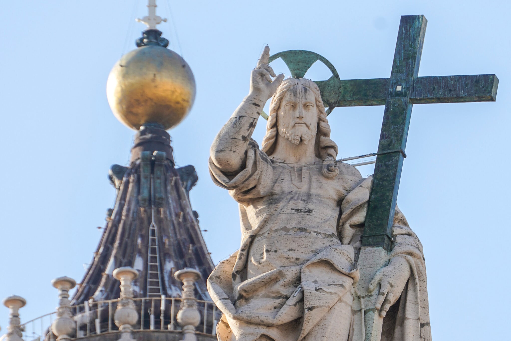 A statue of Jesus Christ on the facade of St Peters Basilica at the Vatican representing the theological roots of the phrase Christ is King now at the center of an antisemitism debate