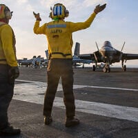 This image provided by US Central Command shows Navy sailors signaling to at F-35C Lightning II on the flight deck of the USS Abraham Lincoln (CVN 72) during operations in support of the war in Iran, on March 3, 2026. (US Navy via AP)