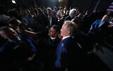 Texas Attorney General Ken Paxton, a Republican candidate for the US Senate, poses for a selfie with a supporter during a primary election night watch party, in Dallas, March 3, 2026. (Julio Cortez/AP)