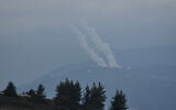 Trails of rockets fired toward Israel from south Lebanon are seen from northern Israel, Wednesday, March 4, 2026. (AP Photo/Ariel Schalit)