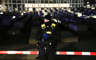 A police officer stands guard at the Holocaust memorial in Berlin, Germany, following a stabbing there on February 21, 2025. (Ebrahim Noroozi/AP)