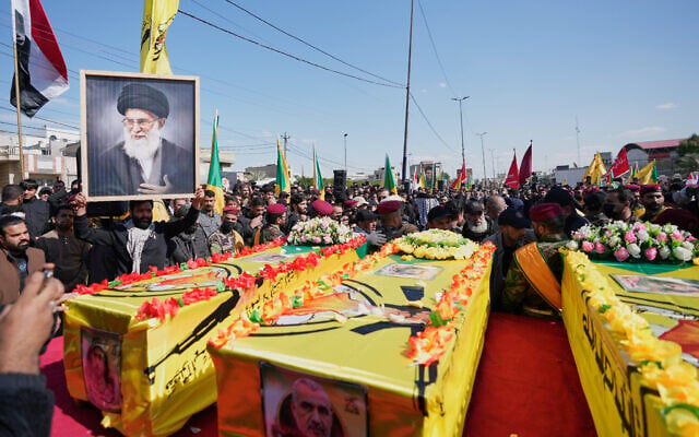 Members from the Popular Mobilization Forces attend the funeral of fighters from Kataib Hezbollah, who were killed in a US airstrike in Babil province southwest of Baghdad, Iraq, March 5, 2026. (AP/Hadi Mizban)