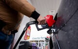 A person fills up their car at a gas station in Montreal on March 5, 2026. (Christopher Katsarov /The Canadian Press via AP)