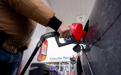 A person fills up their car at a gas station in Montreal on March 5, 2026. (Christopher Katsarov /The Canadian Press via AP) A person fills up their car at a gas station in Montreal on March 5, 2026. (Christopher Katsarov /The Canadian Press via AP)