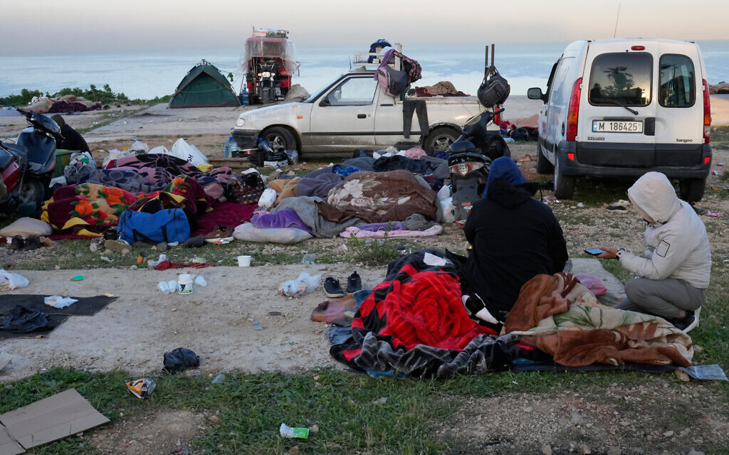 Displaced people fleeing Israeli airstrikes in Beirut's southern suburb of Dahiyeh rest on the Beirut corniche, Lebanon, March 6, 2026. (AP Photo/Hussein Malla)