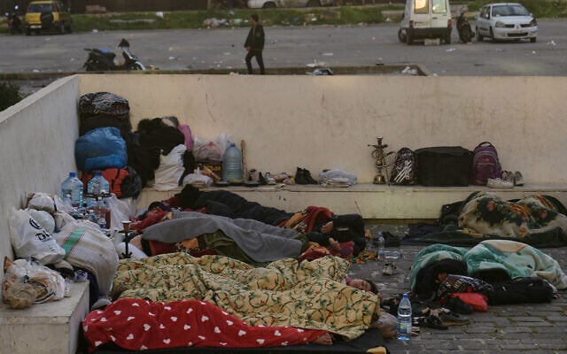 Displaced people fleeing Israeli airstrikes targeting Hezbollah sleep at Martyrs' Square in downtown Beirut, Lebanon, March 7, 2026. (AP Photo/Bilal Hussein)