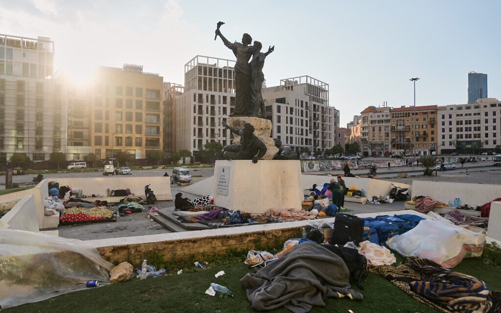 Displaced people fleeing Israeli airstrikes targeting Hezbollah in Dahiyeh sleep at Martyrs' Square in downtown Beirut, Lebanon, March 7, 2026. (AP Photo/Bilal Hussein)