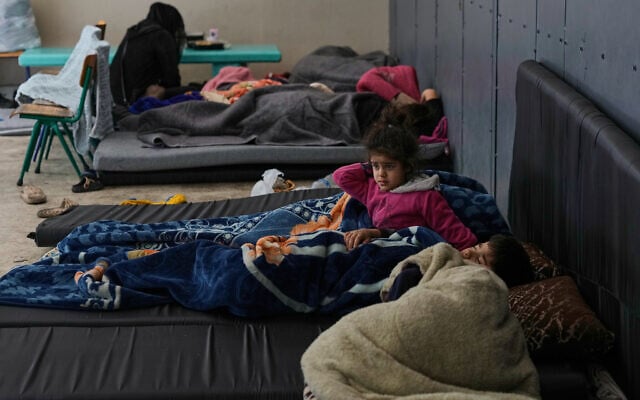 Displaced people fleeing Israeli airstrikes sleep at a school turned into a shelter in Beirut, Lebanon, March 7, 2026. (AP Photo/Bilal Hussein)