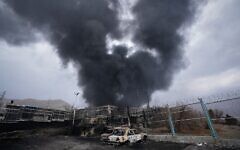 A thick plume of smoke rises from an oil storage facility hit by an Israeli strike late Saturday in Tehran, Iran, March 8, 2026. (AP Photo/Vahid Salemi)