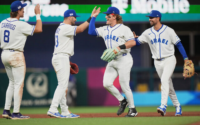 Israel's Cole Carrigg (8), Spencer Horwitz (13) and Harrison Bader, second from right, high-five after defeating Nicaragua in a World Baseball Classic game, March 8, 2026, in Miami. (AP/Lynne Sladky) Israel's Cole Carrigg (8), Spencer Horwitz (13) and Harrison Bader, second from right, high-five after defeating Nicaragua in a World Baseball Classic game, March 8, 2026, in Miami. (AP/Lynne Sladky)