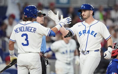 Israel designated hitter Spencer Horwitz, right, is congratulated by Noah Mendlinger (3) after hitting a home run against the Dominican Republic during the fourth inning of a World Baseball Classic game, March 9, 2026, in Miami. (AP/Rebecca Blackwell)