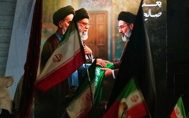 Protesters in Baghdad wave Iranian flags and hold a portrait of Iran's late supreme leader ayatollah Ali Khamenei and his son Mojtaba Khamenei to support his selection as the new supreme leader, March 9, 2026. (AP Photo/Hadi Mizban)
