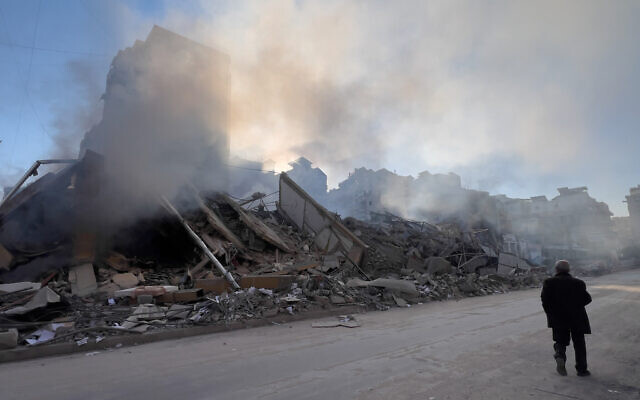 A man passes in front of a destroyed building that housed a branch of Al-Qard Al-Hassan, a non-bank financial institution run by Hezbollah, which was hit by an Israeli airstrike in Dahiyeh, Beirut's southern suburbs, Lebanon, March 10, 2026. (AP/Hussein Malla) A man passes in front of a destroyed building that housed a branch of Al-Qard Al-Hassan, a non-bank financial institution run by Hezbollah, which was hit by an Israeli airstrike in Dahiyeh, Beirut's southern suburbs, Lebanon, March 10, 2026. (AP/Hussein Malla)