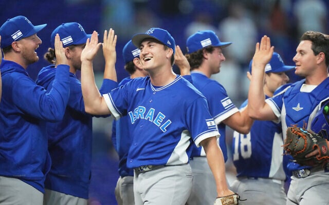 Israel pitcher Ben Simon, center, high-fives his teammates after Israel defeated the Netherlands during a World Baseball Classic game, Tuesday, March 10, 2026, in Miami. (AP /Lynne Sladky) Israel pitcher Ben Simon, center, high-fives his teammates after Israel defeated the Netherlands during a World Baseball Classic game, Tuesday, March 10, 2026, in Miami. (AP /Lynne Sladky)