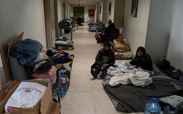 Displaced people fleeing Israeli airstrikes in southern Lebanon and Dahiyeh, Beirut's southern suburbs, settle at the Bir Hassan Technical Institute, which has been turned into a shelter, in Beirut, Lebanon, March 11, 2026. (AP/Bilal Hussein)