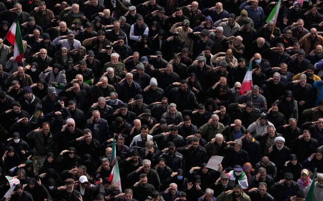 Mourners salute as they attend the funeral procession for senior Iranian military officials and civilians killed during the US-Israel campaign in Tehran, Iran, March 11, 2026. (Vahid Salemi/AP)