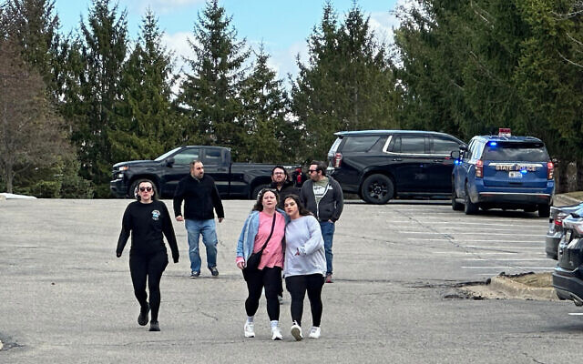 People gather near Temple Israel synagogue in West Bloomfield Township, Michigan, amid a ramming and shooting attack, March 12, 2026. (AP Photo/Corey Williams) People gather near Temple Israel synagogue in West Bloomfield Township, Michigan, amid a ramming and shooting attack, March 12, 2026. (AP Photo/Corey Williams)