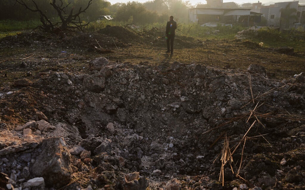 A man looks a the site struck by an Iranian missile in Zarzir, northern Israel, March 13, 2026. (AP Photo/Ariel Schalit) A man looks a the site struck by an Iranian missile in Zarzir, northern Israel, March 13, 2026. (AP Photo/Ariel Schalit)
