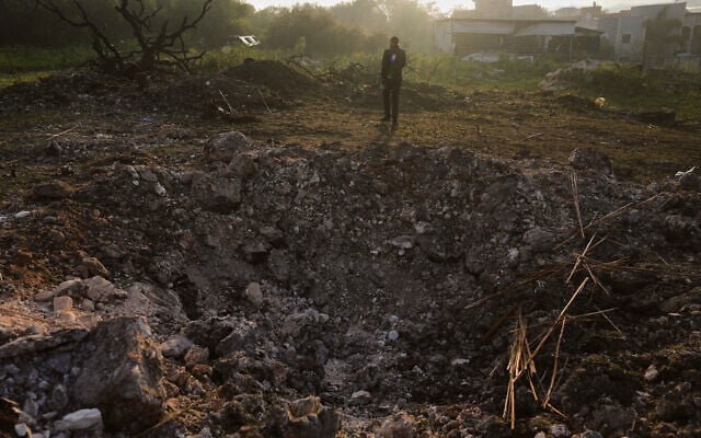 A man looks a the site struck by an Iranian missile in Zarzir, northern Israel, March 13, 2026. (AP Photo/Ariel Schalit) A man looks a the site struck by an Iranian missile in Zarzir, northern Israel, March 13, 2026. (AP Photo/Ariel Schalit)