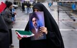 A woman holds a picture of Iran's Supreme Leader Ayatollah Mojtaba Khamenei during the annual anti-Israeli Quds Day, or Jerusalem Day, rally in support of Palestinians in Tehran, Iran, March 13, 2026. (AP/Vahid Salemi)