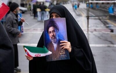 A woman holds a picture of Iran's Supreme Leader Ayatollah Mojtaba Khamenei during the annual anti-Israeli Quds Day, or Jerusalem Day, rally in support of Palestinians in Tehran, Iran, March 13, 2026. (AP/Vahid Salemi)