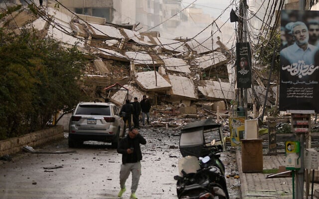 People walk along a street blocked by the rubble of a building destroyed in an Israeli airstrike in Dahiyeh, Beirut's southern suburbs, Lebanon, March 14, 2026. (AP Photo/Hassan Ammar) People walk along a street blocked by the rubble of a building destroyed in an Israeli airstrike in Dahiyeh, Beirut's southern suburbs, Lebanon, March 14, 2026. (AP Photo/Hassan Ammar)
