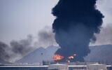 FILE: A fire and plume of smoke rise after, according to authorities, debris from an intercepted Iranian drone struck an oil facility in Fujairah, United Arab Emirates, March 14, 2026.(AP Photo/Altaf Qadri)