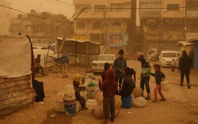 Palestinians collect water in jerrycans during a sandstorm in Gaza City, March 14, 2026. (AP Photo/Jehad Alshrafi) Palestinians collect water in jerrycans during a sandstorm in Gaza City, March 14, 2026. (AP Photo/Jehad Alshrafi)