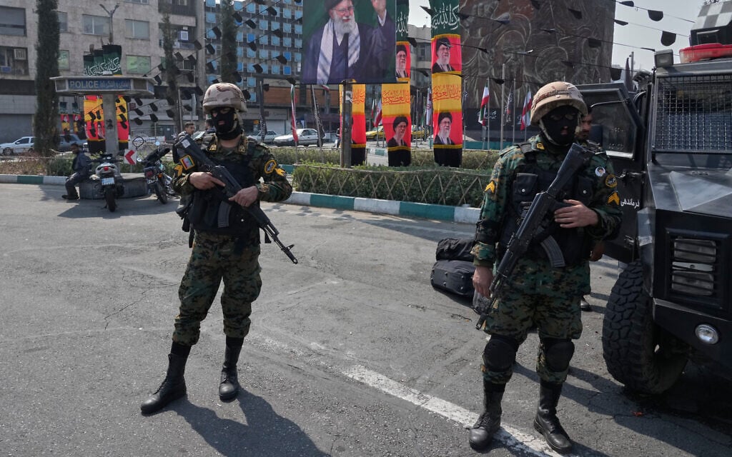 Iranian security forces stand guard next the banners showing portraits of the late supreme leader Ayatollah Ali Khamenei at the Enqelab-e-Eslami, or Islamic Revolution, square in downtown Tehran, Iran, March 14, 2026. (AP Photo/Vahid Salemi)