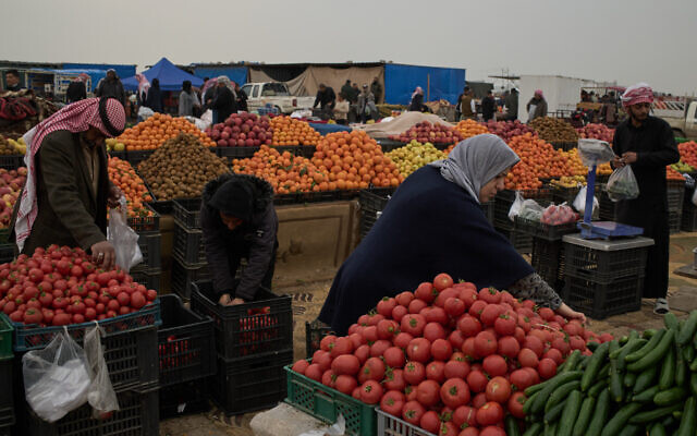 Customers buy vegetables and fruits at a local market in Kawa Camp, which houses Iranian Kurdish refugees who fled Iran following the 1979 Islamic Revolution, in the outskirts of Irbil, Iraq, Saturday, March 14, 2026. (AP Photo/Leo Correa) Customers buy vegetables and fruits at a local market in Kawa Camp, which houses Iranian Kurdish refugees who fled Iran following the 1979 Islamic Revolution, in the outskirts of Irbil, Iraq, Saturday, March 14, 2026. (AP Photo/Leo Correa)