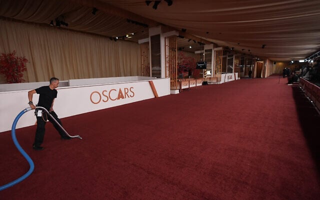 A man vacuums an empty red carpet March 14, 2026, at the Dolby Theatre in Los Angeles, the night before the 98th Academy Awards ceremony. (AP Photo/Gregory Bull) A man vacuums an empty red carpet March 14, 2026, at the Dolby Theatre in Los Angeles, the night before the 98th Academy Awards ceremony. (AP Photo/Gregory Bull)