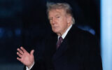US President Donald Trump gestures to the media as he walks on the South Lawn upon his arrival to the White House, March 15, 2026, in Washington. (AP Photo/Jose Luis Magana)