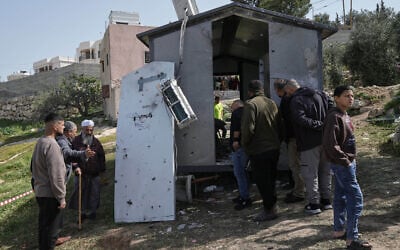 Palestinians inspect the damage at a beauty salon after a deadly Iranian strike in the West Bank village of Beit Awwa, near Hebron, March 19, 2026. (AP/Mahmoud Illean)