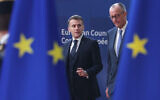 Germany's Chancellor Friedrich Merz, right, and French President Emmanuel Macron walk together as they arrive for the EU summit at the European Council building in Brussels, March 19, 2026. (AP Photo/Omar Havana)