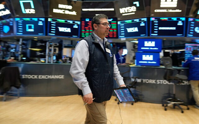 A trader works on the floor at the New York Stock Exchange in New York, March 19, 2026. (AP Photo/Seth Wenig)