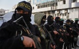 Illustrative: Armed members of Hamas and Islamic Jihad greet people gathering for Eid al-Fitr prayers in Gaza City, March 20, 2026. (AP/Abdel Kareem Hana)