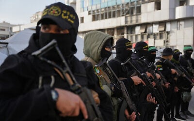 Illustrative: Armed members of Hamas and Islamic Jihad greet people gathering for Eid al-Fitr prayers in Gaza City, March 20, 2026. (AP/Abdel Kareem Hana)